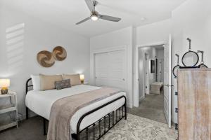 a bedroom with a bed and a ceiling fan at New 4 bed 3 and half bath with pool, hot tub, waterslide and PS5 in Saint George Municipal Airport +59 photos