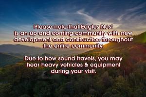 a sign that says please note that eagle nest is an up and coming community with at Moose's River Crossing at Eagles Nest in Banner Elk