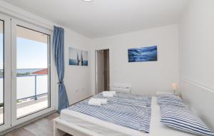 Lovely Home In Privlaka في Glavan: غرفة نوم بها سرير ونافذة كبيرة