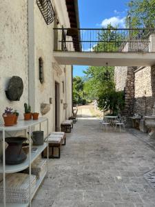 a patio with tables and chairs and a balcony at Villa Allegrini in Segni