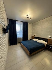 a bedroom with a large bed and a window at Готель Чертур in Yavory