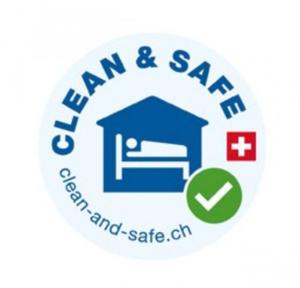 Un logotipo para la clínica de emergencias de Ham and Saas. en SwissHut Idyllic Farm Stay, en Sigriswil