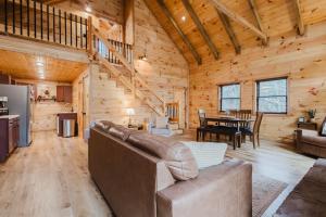 a living room and dining room in a log cabin at The Lazy Maple in Red River Gorge in Rogers