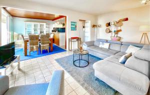 a living room with a couch and a table at Charmant Appartement Vue Mer in Saint-Georges-de-Didonne