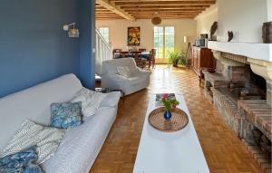 a living room with a couch and a fireplace at Belle Maison Landaise in Mimizan