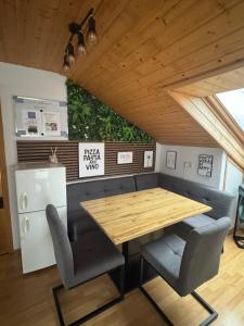 a kitchen with a table and chairs and a refrigerator at Ferien/Monteur Wohnung Gapp in Bad Waldsee
