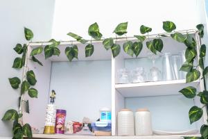 a shelf with a plant on top of it at Velora Suites Kilifi in Kilifi