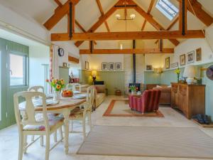a dining room and living room with a table and chairs at 2 Bed in Bamburgh 36344 in Kyloe