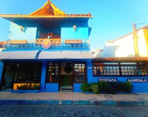 a blue building with a sign in front of it at Pousada Mandala - Búzios in Búzios