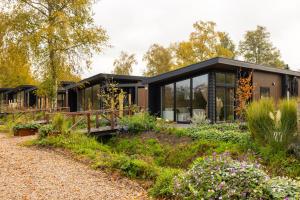 a house in the woods with a garden at De Leughte Resort Renswoude in Renswoude