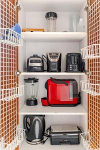 a kitchen pantry with various appliances on shelves at City views Air-conditioning Heated pool in Envigado