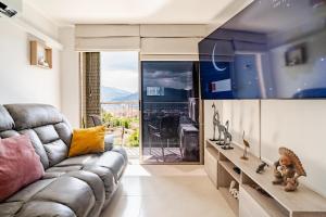 a living room with a couch and a large window at City views Air-conditioning Heated pool in Envigado