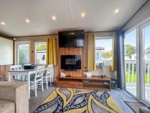 a living room with a television and a table with chairs at 7 Burnham in Burnham on Sea