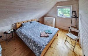 a bedroom with a bed and a ladder in a room at 3 Bedroom Awesome Home In Jasien in Jasień