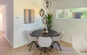 a dining room with a black table and chairs at Amazing Home In Zeijen With Wifi in Peest