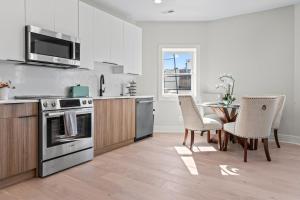 a kitchen with a table and chairs and a stove at Lux 2BD Apartment in Dupont Circle Washington DC in Washington
