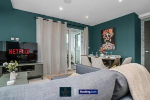 a living room with a couch and a tv at Luxury 3BDR Flat - Short Lets & Serviced Accommodation Wembley With Wi-Fi, Gym & Cinema in London