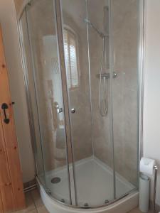 a shower with a glass door in a bathroom at Coastline cottage Pakefield, 2 minutes walk to the beach in Pakefield +34 photos