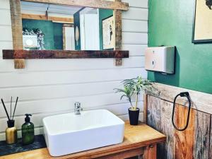 a bathroom with a white sink and a mirror at Le Ranch Camping et Glamping in Madranges +43 photos