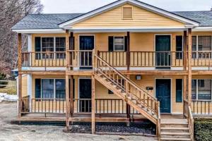 a house with a large deck and stairs at Champagne Supernova & Ludlow Lax in Ludlow