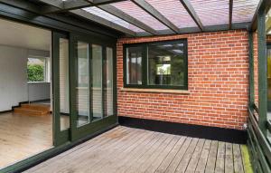 a brick building with a window and a wooden deck at 1 Bedroom Nice Home In Hurup Thy in Ullerup +14 photos