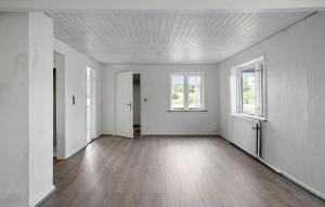 an empty room with white walls and wood floors at 1 Bedroom Nice Home In Hurup Thy in Ullerup