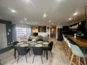 a dining room and living room with a table and chairs at Maison chic et paisible, terrasse, spa et campagne in Merceuil +34 photos