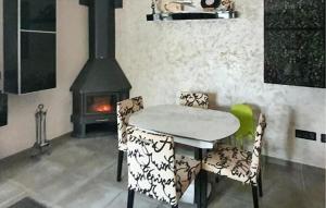 a dining room with a table and chairs and a stove at Awesome Home In Alcora With Heated Swimming Pool in San Juan de Moró