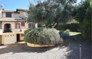 a large bush in front of a house at Cozy Home In Tarquinia in Porto Clementino +25 photos