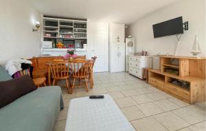 a living room with a kitchen and a dining room table at Beautiful Apartment In Le Grau-Du-Roi With Wifi in Le Grau-du-Roi