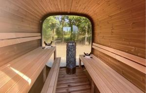 an inside view of a sauna with two rabbits sitting on benches at Amazing Home In Glesborg With Sauna in Fjellerup Strand +21 photos