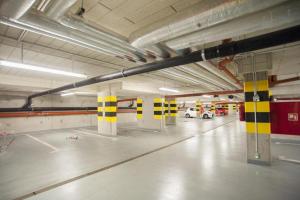 an empty parking garage with a car parked in it at Good Time Apartments Kościelna 17 19 in Poznań