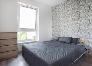 a bedroom with a large bed and a window at Good Time Apartments Kościelna 17 19 in Poznań +25 photos