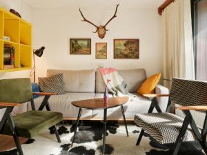 a living room with a couch and a table at Idyllic cottage in beautiful Alps in Zgornje Jezersko