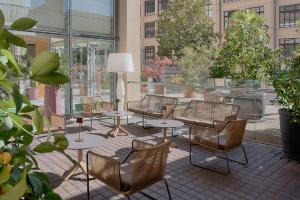 a group of chairs and tables in a patio at NH Torino Lingotto Congress in Turin