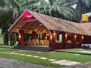 a building with a restaurant with tables and chairs at Nomad's Nook in Ponnampet