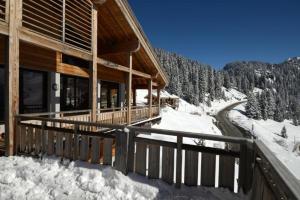 a log cabin in the snow with a rail at Résidence Les Portes du Grand Massif - Flaine in Flaine +7 photos
