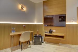 a kitchen with a table and a chair and a counter at Hotel Warma Palace in Yeola