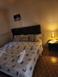 a bedroom with a bed with a bedspread with horses on it at Guy ville house in Temara
