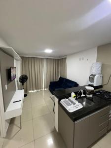 a hotel room with a kitchen and a living room at Seller Residence Centro in Sobral +129 photos