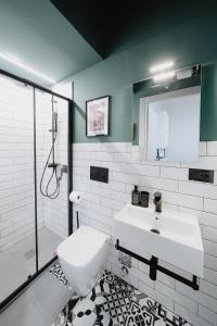 a white bathroom with a sink and a shower at Mole Turin Suite in Turin +28 photos