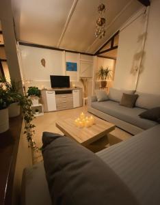 a living room with a couch and a table with candles at Guy ville house in Temara