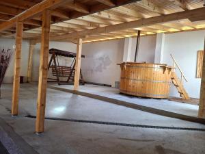 a large room with a large wooden tub in it at Cabana Denisa in Râu de Mori