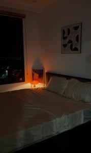 a bedroom with a large bed with a window at 1998Homestay Căn hộ 1n1wc city view tiện nghi in An Khê