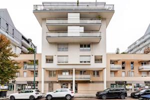 a tall building with cars parked in front of it at Annecy gare in Annecy
