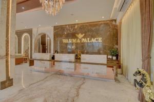 a lobby with a versaria palace sign on the wall at Hotel Warma Palace in Yeola