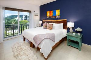 a bedroom with a large bed and a large window at Gorgeous Penthouse across from Beach with Ocean Views! in Punta Mita +28 photos