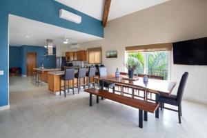 a dining room and kitchen with a table and chairs at Gorgeous Penthouse across from Beach with Ocean Views! in Punta Mita