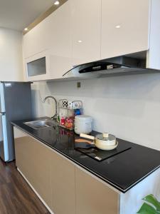 a kitchen with a sink and a counter top at 1998Homestay Căn hộ 1n1wc city view tiện nghi in An Khê +7 photos