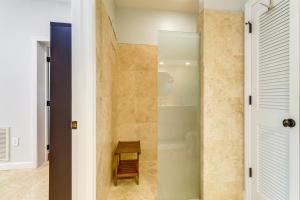 a bathroom with a shower with a glass door at Walk to Wabasso Beach Home with Hot Tub and Bikes in Sebastian +37 photos